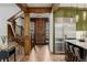 Hallway and staircase displaying hardwood floors, wooden trim, and open layout to kitchen at 1332 S Lafayette St, Denver, CO 80210