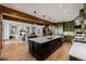 Open concept kitchen with large center island, stainless appliances, and wood beams at 1332 S Lafayette St, Denver, CO 80210