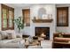 Living room featuring a fireplace, neutral tones, and beautiful window trim at 1332 S Lafayette St, Denver, CO 80210