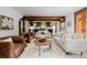 Spacious living room with hardwood floors, decorative beams, and open to the kitchen at 1332 S Lafayette St, Denver, CO 80210