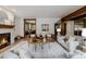 Open living room featuring a fireplace, beamed ceilings, hardwood floors and elegant decor at 1332 S Lafayette St, Denver, CO 80210