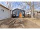 View of the back of the house, showing a patio and landscaping at 3736 S Lincoln St, Englewood, CO 80113