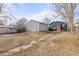 Large backyard with detached garage and a paved pathway at 3736 S Lincoln St, Englewood, CO 80113