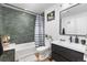 Modern bathroom with dark green tile and a sleek vanity at 3736 S Lincoln St, Englewood, CO 80113