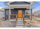 Bright, welcoming front porch with wooden steps and railings at 3736 S Lincoln St, Englewood, CO 80113