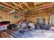 Unfinished garage with plywood walls, concrete floor, and exposed rafters ready for your personal touches at 3736 S Lincoln St, Englewood, CO 80113