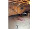 Unfinished garage with plywood walls, concrete floor, and exposed rafters ready for your personal touches at 3736 S Lincoln St, Englewood, CO 80113