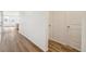 Light and airy hallway with wood-look flooring at 1546 Farmstead St, Brighton, CO 80601