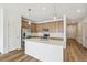 Modern kitchen with island, stainless steel appliances, and light wood cabinets at 1546 Farmstead St, Brighton, CO 80601