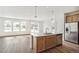 Modern kitchen with island, stainless steel appliances, and light wood cabinets at 1546 Farmstead St, Brighton, CO 80601