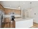 Modern kitchen with stainless steel appliances and light wood cabinets at 1546 Farmstead St, Brighton, CO 80601