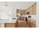 Modern kitchen with island, stainless steel appliances, and light wood cabinets at 1546 Farmstead St, Brighton, CO 80601