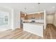 Modern kitchen with island, stainless steel appliances, and light wood cabinets at 1546 Farmstead St, Brighton, CO 80601