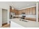 Modern kitchen with island, stainless steel appliances, and light wood cabinets at 1546 Farmstead St, Brighton, CO 80601