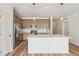 Modern kitchen with island, stainless steel appliances, and light wood cabinets at 1546 Farmstead St, Brighton, CO 80601