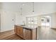 Modern kitchen with island, stainless steel appliances, and light wood cabinets at 1546 Farmstead St, Brighton, CO 80601