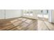 Sunlit living room with hardwood floors and sliding glass doors at 1546 Farmstead St, Brighton, CO 80601