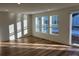 Bright and spacious living room with hardwood floors and sliding glass door at 1546 Farmstead St, Brighton, CO 80601