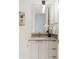 Bright bathroom features a clean vanity with a sink and decorative floral arrangement and sleek fixtures at 1750 Wewatta St # 809, Denver, CO 80202