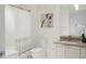 Clean bathroom showcases a vanity with a sink, toilet, and a shower/tub with a stylish shower curtain at 1750 Wewatta St # 809, Denver, CO 80202
