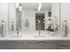Modern bathroom features double sinks, sleek lighting, and a view into the shower, creating a bright ambiance at 1750 Wewatta St # 809, Denver, CO 80202