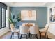 Elegant dining room featuring a glass-top table, comfortable chairs, and a modern art piece at 1750 Wewatta St # 809, Denver, CO 80202