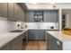Well-appointed kitchen with gray cabinets, white countertops, and stainless steel appliances, including a gas range at 1750 Wewatta St # 809, Denver, CO 80202