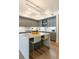 Modern kitchen featuring gray cabinets, white countertops, a large island, and stylish pendant lighting at 1750 Wewatta St # 809, Denver, CO 80202