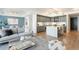 Bright living space featuring an open floor plan with modern gray cabinets and stainless steel appliances at 1750 Wewatta St # 809, Denver, CO 80202
