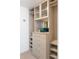 Well-designed walk-in closet features drawers, shelving, and glass-door storage for efficient organization at 1750 Wewatta St # 809, Denver, CO 80202