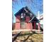 Charming red brick home featuring a covered porch and unique architectural details at 1449 N Downing St, Denver, CO 80218