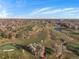 Drone view of a green golf course with trees, a pond, and sand traps at 2207 E 25Th, Denver, CO 80205