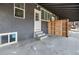 Back porch with concrete steps, white door, and view of backyard offers convenient outdoor access at 2207 E 25Th, Denver, CO 80205
