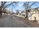 Gravel driveway, detached garage, and additional yard space at 2207 E 25Th, Denver, CO 80205