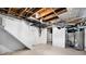 Unfinished basement with exposed ceiling, painted walls, and wood-look flooring provides storage space at 2207 E 25Th, Denver, CO 80205