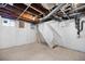 Unfinished basement space with exposed ceiling, stairs, and a small window at 2207 E 25Th, Denver, CO 80205