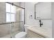 Stylish bathroom features a glass shower, modern vanity and a large mirror at 2207 E 25Th, Denver, CO 80205