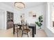 Well-lit dining room showcasing modern decor, dining table, and a view into the kitchen at 2207 E 25Th, Denver, CO 80205