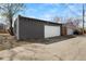 Detached garage with white door and a concrete driveway at 2207 E 25Th, Denver, CO 80205