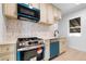 Renovated kitchen boasts modern appliances, stylish backsplash, and plenty of counter space at 2207 E 25Th, Denver, CO 80205