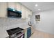 Modern kitchen with teal appliances and white cabinets at 2207 E 25Th, Denver, CO 80205