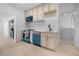 The renovated kitchen features modern appliances, stylish backsplash, and ample cabinetry at 2207 E 25Th, Denver, CO 80205