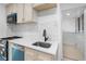 Newly remodeled kitchen with white cabinets and teal appliances at 2207 E 25Th, Denver, CO 80205