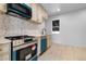 Updated kitchen with modern appliances, stylish backsplash, and ample counter space at 2207 E 25Th, Denver, CO 80205