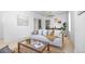 Cozy living room showcases a comfortable couch, decorative pillows, and neutral color palette at 2207 E 25Th, Denver, CO 80205