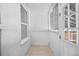Enclosed porch with white brick wall, lots of windows and wood floor at 2207 E 25Th, Denver, CO 80205