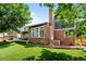Spacious backyard with lush green grass and a covered patio, perfect for outdoor living and entertaining at 5795 S Pagosa Way, Centennial, CO 80015