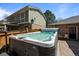 Close-up of a luxurious hot tub and stamped concrete patio in the home's backyard at 5795 S Pagosa Way, Centennial, CO 80015