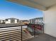 Apartment balcony with a black metal railing and view of the neighborhood at 6153 N Ceylon St # 307, Denver, CO 80249