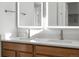 Close up of bright bathroom featuring double vanity and framed mirrors at 6153 N Ceylon St # 307, Denver, CO 80249